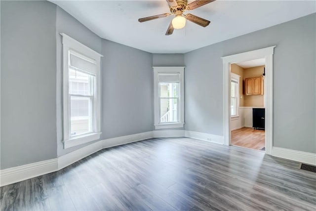 26 Fountain St, Rochester, NY 14620 - unfurnished room featuring healthy amount of natural light, wood finished floors, and a ceiling fan