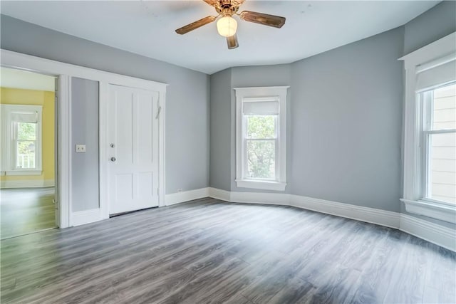 26 Fountain St, Rochester, NY 14620 - unfurnished bedroom with multiple windows, wood finished floors, a closet, and ceiling fan