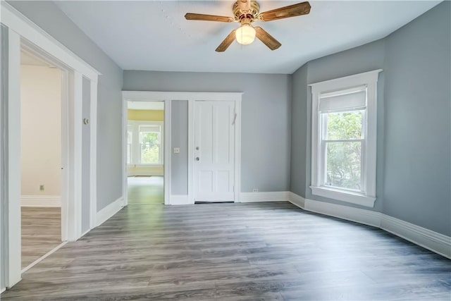 26 Fountain St, Rochester, NY 14620 - unfurnished bedroom featuring multiple windows and wood finished floors