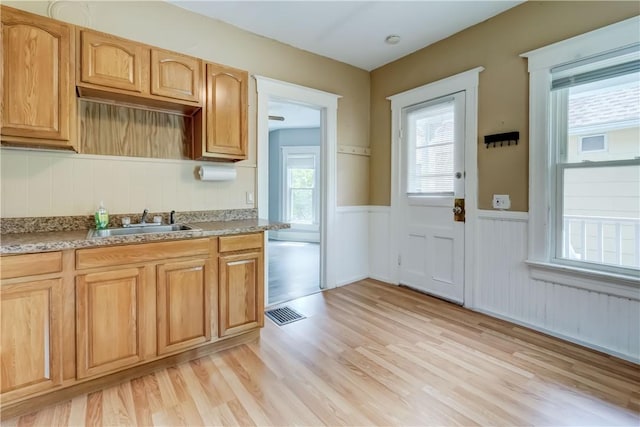 26 Fountain St, Rochester, NY 14620 - kitchen with a wainscoted wall, light wood finished floors, and light countertops