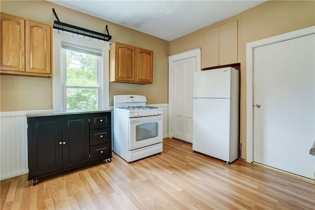 26 Fountain St, Rochester, NY 14620 - kitchen with white appliances, light wood-type flooring, light countertops, and dark cabinetry