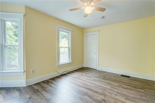 26 Fountain St, Rochester, NY 14620 - empty room featuring plenty of natural light, wood finished floors, and ceiling fan