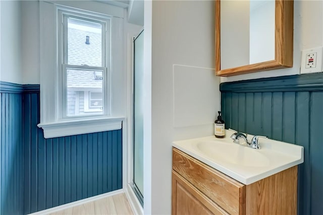 26 Fountain St, Rochester, NY 14620 - bathroom featuring vanity, a stall shower, and a wainscoted wall