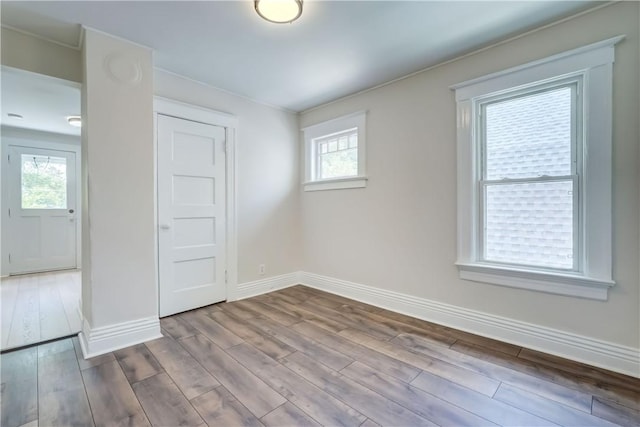 26 Fountain St, Rochester, NY 14620 - unfurnished bedroom featuring wood finished floors and multiple windows