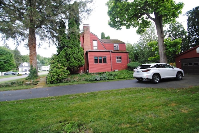 11 Elmwood Ave, Hornellsville, NY 14843 - view of side of property with a yard, a chimney, and asphalt driveway