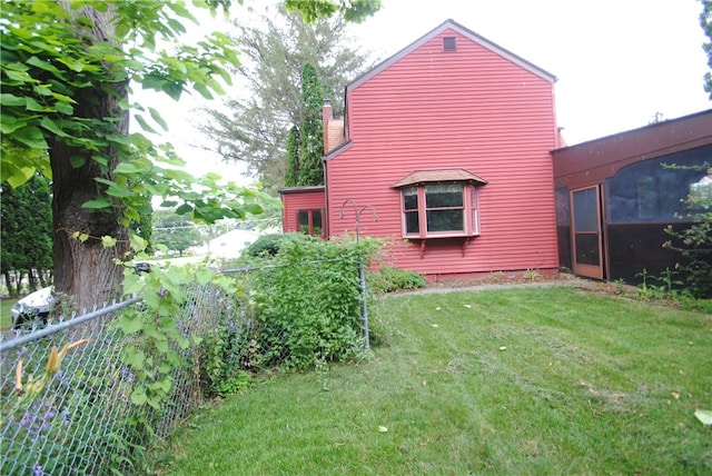 11 Elmwood Ave, Hornellsville, NY 14843 - view of side of home with a sunroom and a chimney