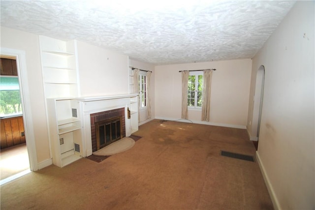 11 Elmwood Ave, Hornellsville, NY 14843 - unfurnished living room with a fireplace, carpet, and a textured ceiling