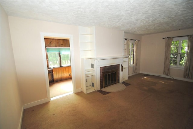 11 Elmwood Ave, Hornellsville, NY 14843 - unfurnished living room with a brick fireplace, carpet floors, and a textured ceiling