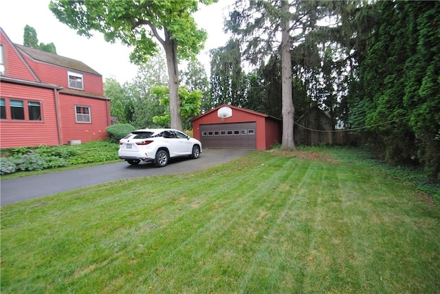 11 Elmwood Ave, Hornellsville, NY 14843 - view of grassy yard featuring a detached garage and an outdoor structure