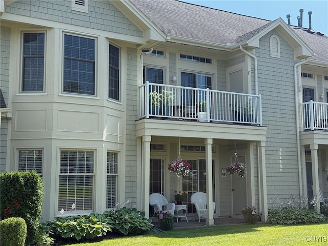 2301 Greymoor Way, Lysander, NY 13027 - back of house featuring a shingled roof and a balcony