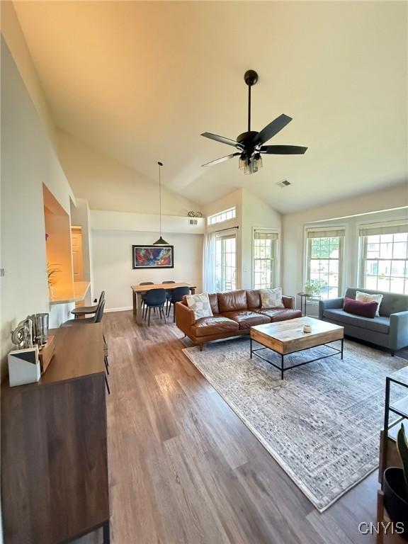 2301 Greymoor Way, Lysander, NY 13027 - living area with wood finished floors, vaulted ceiling, and ceiling fan