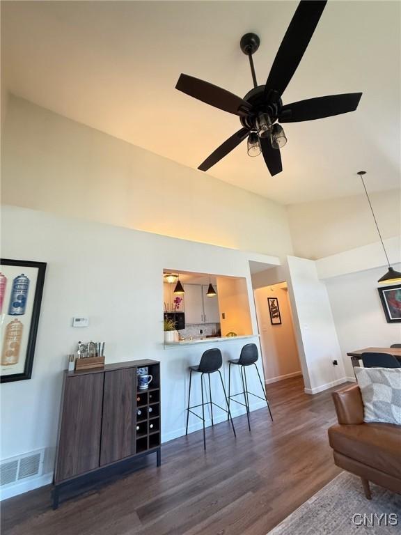 2301 Greymoor Way, Lysander, NY 13027 - bar featuring dark wood-style floors, a ceiling fan, vaulted ceiling, and decorative light fixtures