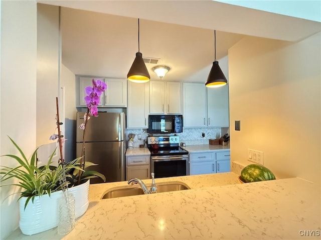 2301 Greymoor Way, Lysander, NY 13027 - kitchen featuring stainless steel appliances, hanging light fixtures, decorative backsplash, and light stone countertops
