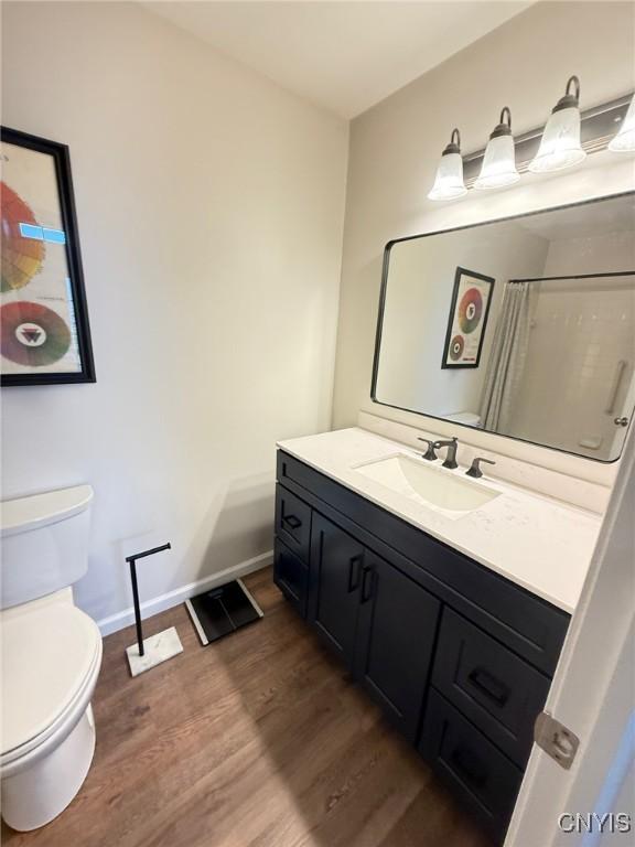 2301 Greymoor Way, Lysander, NY 13027 - full bathroom featuring wood finished floors, vanity, and a shower with shower curtain