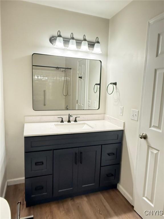2301 Greymoor Way, Lysander, NY 13027 - full bathroom with vanity, wood finished floors, and a shower