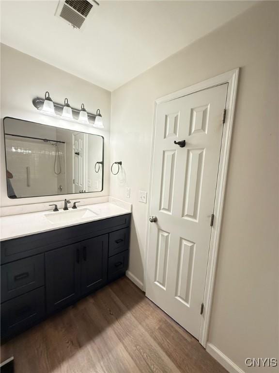 2301 Greymoor Way, Lysander, NY 13027 - bathroom featuring wood finished floors, vanity, and a shower