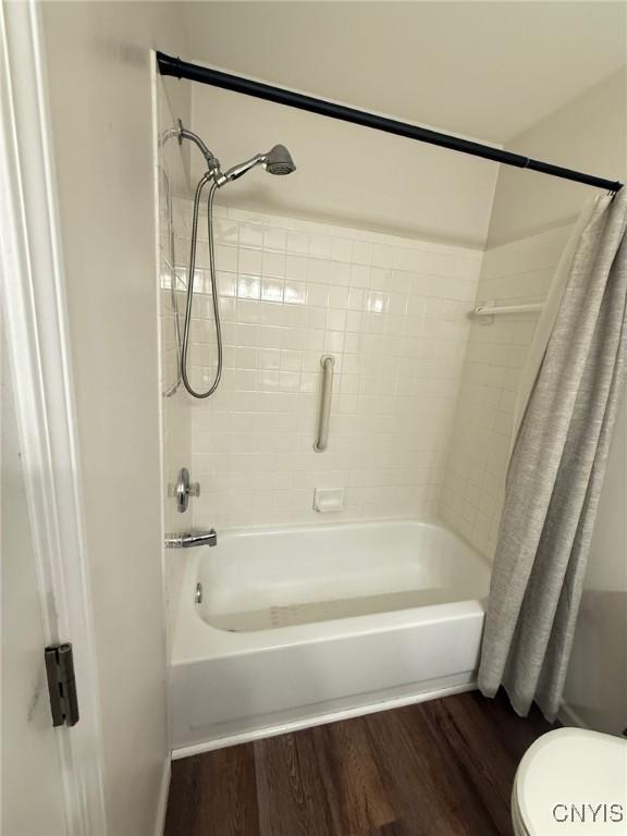 2301 Greymoor Way, Lysander, NY 13027 - bathroom with shower / bath combination with curtain and wood finished floors