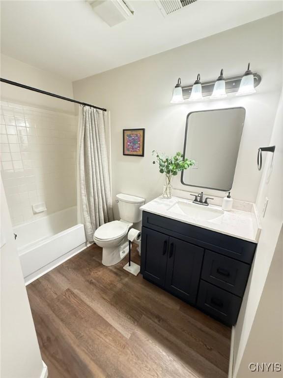 2301 Greymoor Way, Lysander, NY 13027 - full bath with wood finished floors, vanity, and shower / bath combination with curtain