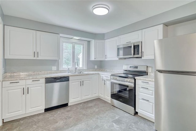 2862 Culver Rd, Irondequoit, NY 14622 - kitchen with appliances with stainless steel finishes, light countertops, and white cabinetry