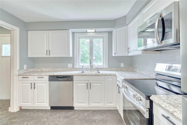 2862 Culver Rd, Irondequoit, NY 14622 - kitchen with appliances with stainless steel finishes, white cabinets, light countertops, and light marble finish flooring