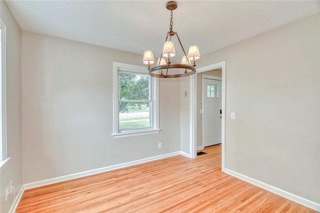 2862 Culver Rd, Irondequoit, NY 14622 - spare room featuring a chandelier and light wood finished floors