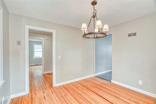 2862 Culver Rd, Irondequoit, NY 14622 - spare room featuring a chandelier and light wood finished floors