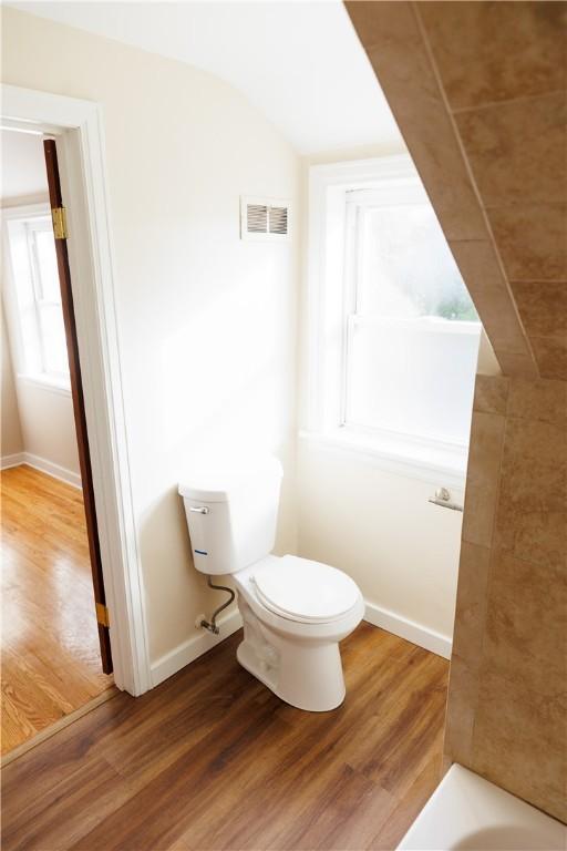 2862 Culver Rd, Irondequoit, NY 14622 - full bathroom with wood finished floors, a tub to relax in, and lofted ceiling