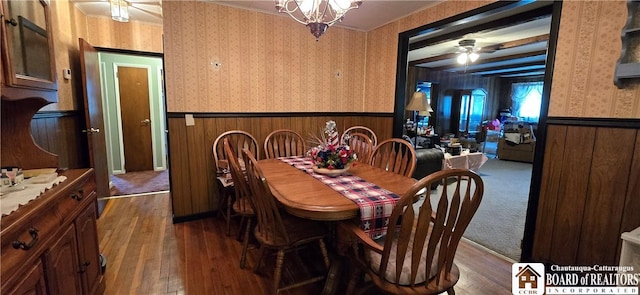 1710 Haskell Pkwy, Portville, NY 14760 - dining area with wainscoting, wallpapered walls, hardwood / wood-style floors, ceiling fan, and a chandelier