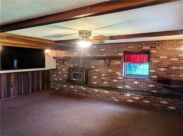 310 E Green St, Smethport Boro, PA 16749 - unfurnished living room featuring carpet, ceiling fan, a textured ceiling, wood walls, and a wood stove