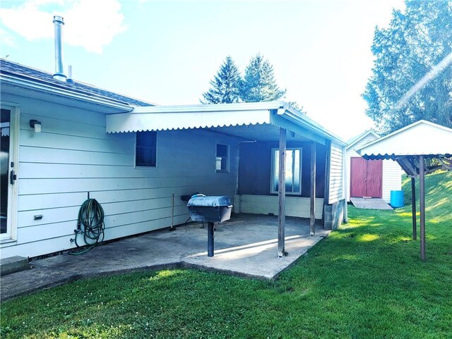 310 E Green St, Smethport Boro, PA 16749 - rear view of house featuring a lawn and a patio area