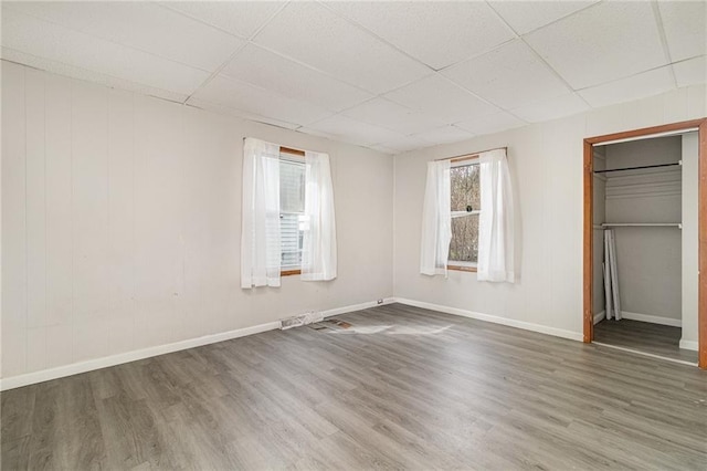 430 Ridgeway Ave, Rochester, NY 14615 - unfurnished bedroom with a paneled ceiling, wood finished floors, and a walk in closet