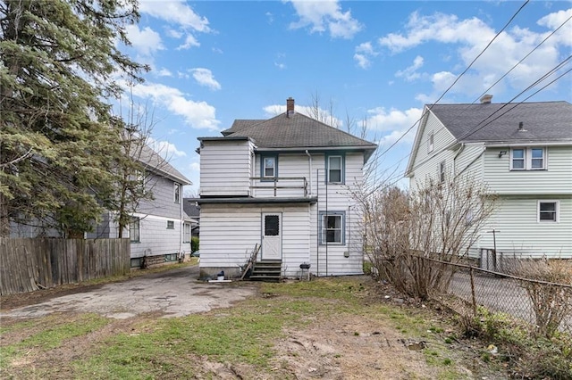 430 Ridgeway Ave, Rochester, NY 14615 - back of house with entry steps, a shingled roof, and a chimney