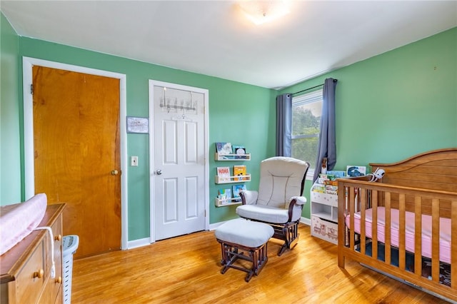 529 Fetzner Rd, Greece, NY 14626 - bedroom featuring light wood-type flooring and a nursery area