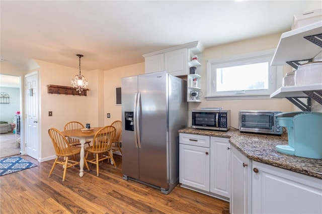 529 Fetzner Rd, Greece, NY 14626 - kitchen with appliances with stainless steel finishes, white cabinetry, dark wood-style flooring, a chandelier, and decorative light fixtures