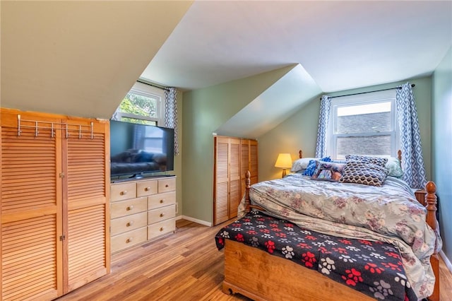 529 Fetzner Rd, Greece, NY 14626 - bedroom featuring wood finished floors, multiple windows, and lofted ceiling