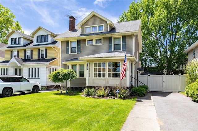 1043 Genesee Park Blvd, Rochester, NY 14619 - american foursquare style home featuring a gate, a chimney, a front yard, roof with shingles, and driveway