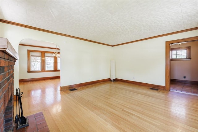 1043 Genesee Park Blvd, Rochester, NY 14619 - unfurnished living room featuring wood finished floors, ornamental molding, and arched walkways