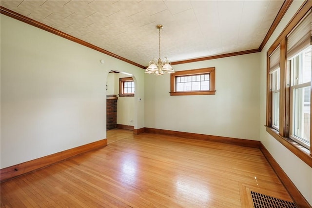 1043 Genesee Park Blvd, Rochester, NY 14619 - empty room with arched walkways, a chandelier, light wood-style floors, and crown molding