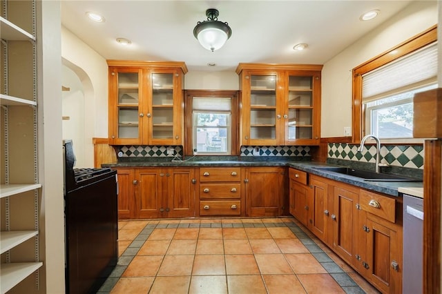 1043 Genesee Park Blvd, Rochester, NY 14619 - kitchen featuring range, stainless steel dishwasher, tasteful backsplash, and brown cabinets
