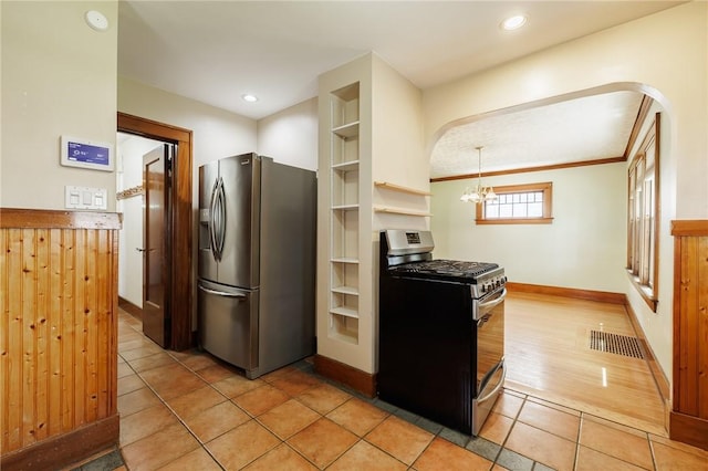 1043 Genesee Park Blvd, Rochester, NY 14619 - kitchen featuring appliances with stainless steel finishes, arched walkways, a chandelier, light tile patterned flooring, and open shelves