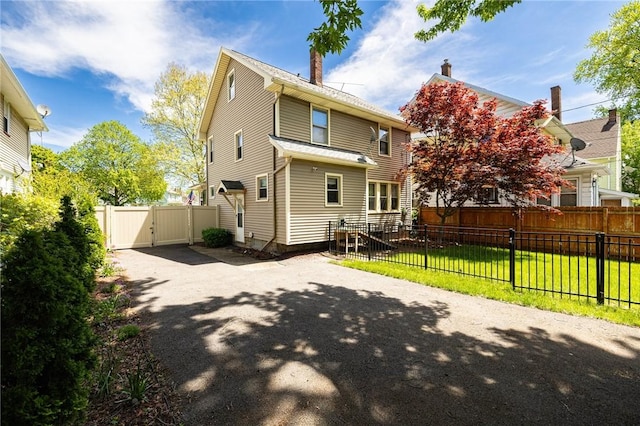 1043 Genesee Park Blvd, Rochester, NY 14619 - back of house featuring a gate and driveway