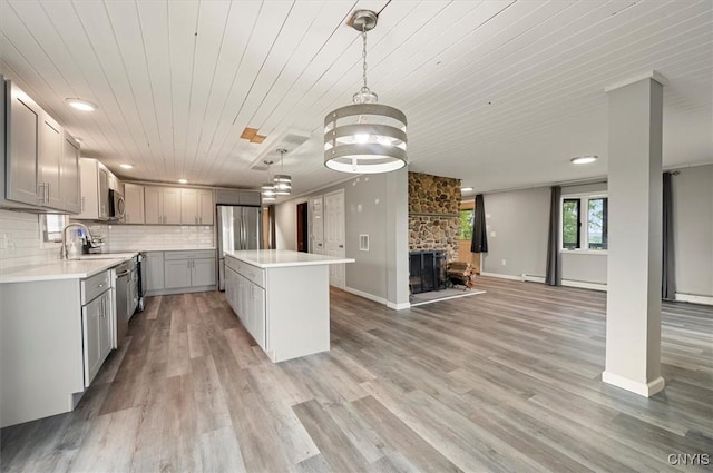 5640 Fearon Rd, Eaton, NY 13408 - kitchen featuring gray cabinetry, appliances with stainless steel finishes, wooden ceiling, a center island, and open floor plan