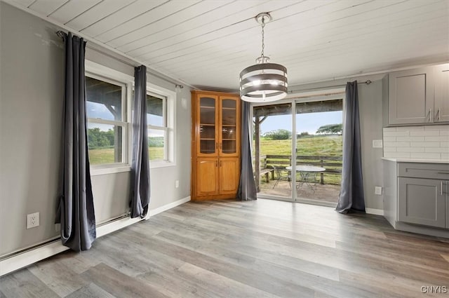 5640 Fearon Rd, Eaton, NY 13408 - unfurnished dining area with healthy amount of natural light, light wood finished floors, a chandelier, wooden ceiling, and a baseboard radiator