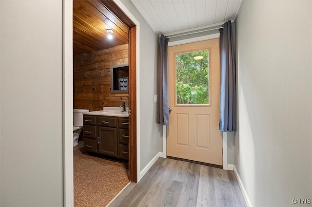 5640 Fearon Rd, Eaton, NY 13408 - doorway with wood ceiling, light wood-style floors, and wooden walls