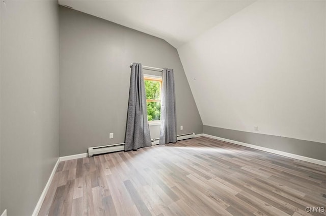 5640 Fearon Rd, Eaton, NY 13408 - empty room featuring lofted ceiling, a baseboard heating unit, and wood finished floors