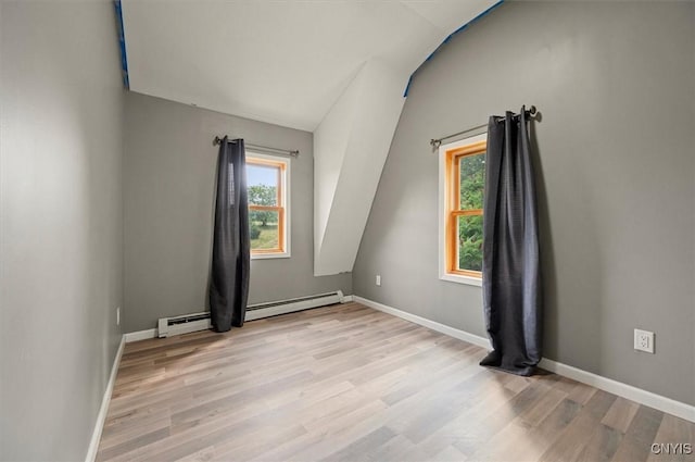 5640 Fearon Rd, Eaton, NY 13408 - additional living space featuring light wood-style flooring, vaulted ceiling, and a baseboard heating unit