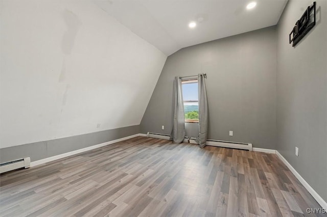 5640 Fearon Rd, Eaton, NY 13408 - unfurnished room featuring vaulted ceiling, wood finished floors, a baseboard heating unit, recessed lighting, and a baseboard radiator