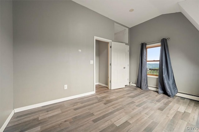 5640 Fearon Rd, Eaton, NY 13408 - unfurnished bedroom with lofted ceiling, light wood-type flooring, a baseboard heating unit, and a baseboard radiator