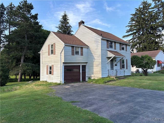 39 Standart Ave, Auburn, NY 13021 - view of front of house with a chimney, a front lawn, asphalt driveway, a shingled roof, and an attached garage