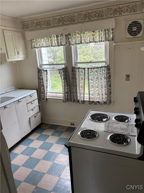 39 Standart Ave, Auburn, NY 13021 - kitchen featuring white range with electric stovetop, white cabinetry, light flooring, light countertops, and ornamental molding